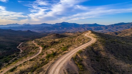 Rugged Desert Landscape Featuring Winding Dirt Roads and Scenic Mountain Backdrop : Generative AI