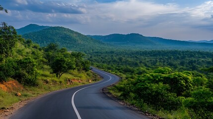 Fototapeta premium Curvy road leading through lush green hills and vibrant nature under a blue sky : Generative AI
