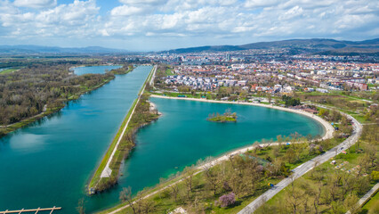 Aerial drone view of Park Jarun in Zagreb, showcasing stunning blue water, lush greenery, and the nearby Sava River Park features excellent bicycle roads, perfect for cycling and outdoor activities