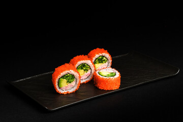 Delicious Fresh Salmon Sushi Rolls Presenting Exquisitely on a Black Background
