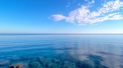 Obraz premium Tranquil seascape with calm clear waters reflecting clouds and a serene blue sky above : Generative AI
