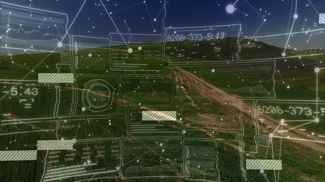 Digital interface animation over aerial view of rural landscape and fields