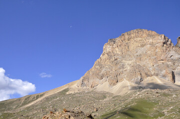 A perfect view of the harsh rocks and green plains from the peak of Shahdag in the Caucasus Mountains