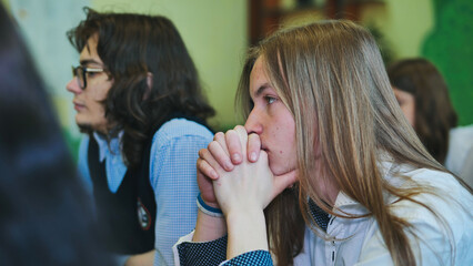 High school students listening attentively to the teacher during a class lesson, showing engagement and focus in their education