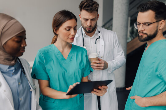 Medical team using digital tablet during hospital consultation