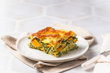 Homemade vegetarian lasagne with pumpkin, spinach and bechamel sauce