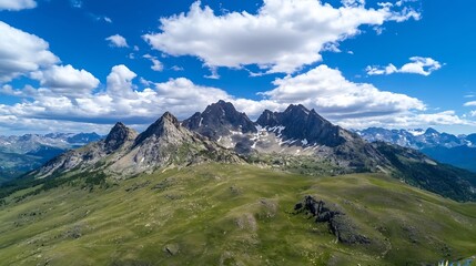 Fototapeta premium Stunning aerial view of majestic mountains under a vibrant blue sky with fluffy clouds : Generative AI