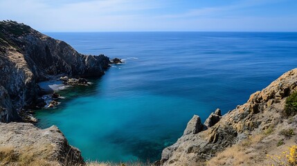 Fototapeta premium Majestic Coastal View of Crystal Clear Water and Rocky Cliffside Under a Bright Blue Sky : Generative AI