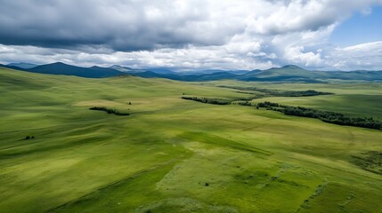 Obraz premium Breathtaking aerial view of rolling green hills under a dramatic cloudy sky : Generative AI