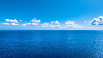 Obraz premium Vast Tranquil Ocean Under Clear Blue Sky with Gentle Waves and Soft Clouds : Generative AI
