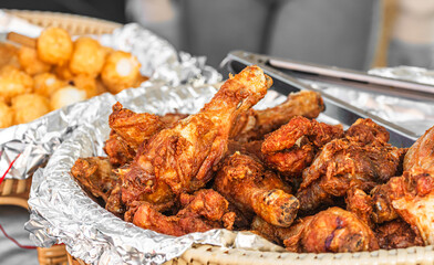 Plate with fried chicken wings at a street food stall
