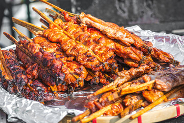 Thai grilled meat skewers on a plate