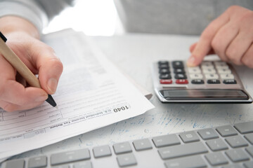 Time to pay taxes. Calculator and computer keyboard for performing financial calculations or filing...