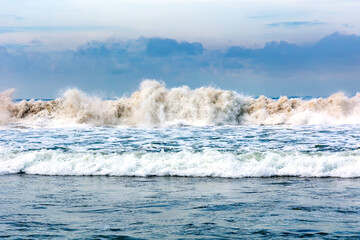 Fototapeta premium Panorama of natural Indian Ocean with big foamy waves crashing on sandy shore. Sri Lanka. Asia 