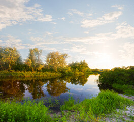 calm river with forest on coast at the sunset