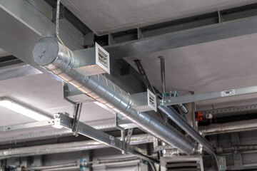 Air heating system for industrial premises, new technologies. Ventilation pipes on the ceiling