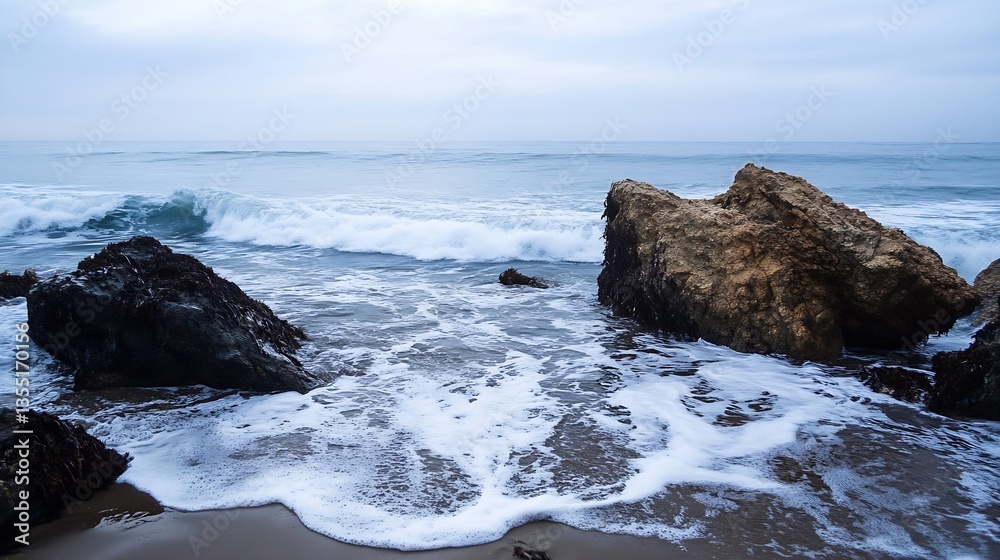 Aufkleber rocky shoreline with waves gently crashing on the beach during a cloudy day : generative ai