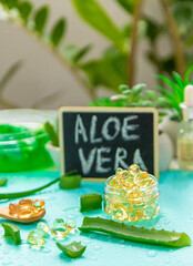 Aloe vera capsules and extract drops. Selective focus.