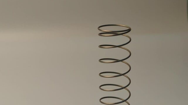 Metal spiral close-up shots on a black background with empty space for advertising
