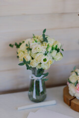 Vase with beautiful peony flowers on table