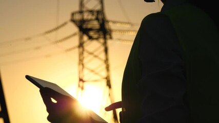 silhouette electrical engineer, work tablet sunset, electric tower, digital hand, engineer field with electric towers works tablet hand, engineer with tablet works near electric poles sunset, data - Powered by Adobe