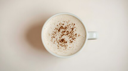 Top View of a Creamy Coffee Mug with Chocolate Sprinkles on Light Pink Surface