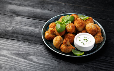 Crispy Breaded Garlic Mushrooms with garlic sauce. Vegetarian, vegan food concept