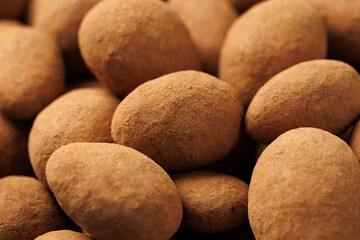 Chocolate coated almonds background. Cocoa coated almonds. Cocoa Dusted Almonds