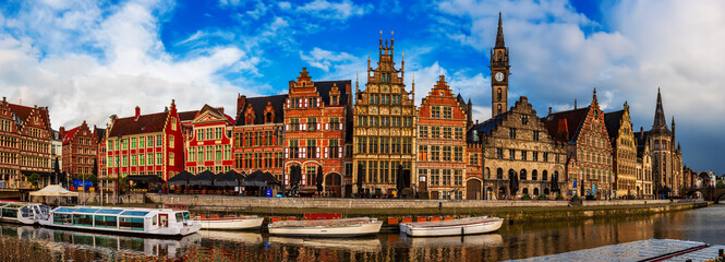 Fototapeta premium Ghent city historical center, tourists boats and colorful buildings on Leie river bank, Belgium