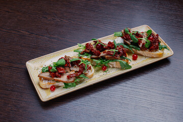 Appetizing sandwiches with meat, greens and berries on a plate.snack