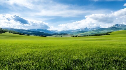 Fototapeta premium Vast green landscape with rolling hills and majestic mountains under a bright blue sky filled with clouds : Generative AI