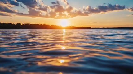 Obraz premium Beautiful sunset over calm water surface reflecting clouds and warm colors creating a serene natural landscape : Generative AI