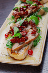 Appetizing sandwiches with meat, greens and berries on a plate.Snack for alcoholic drinks. appetizing food on the table