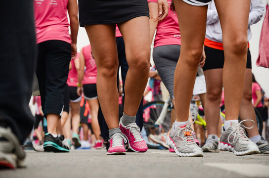 Diverse group at charity marathon in colorful athletic gear, ready to start.
