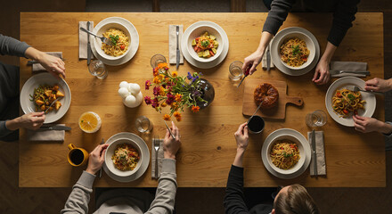 Group of people sharing a meal around a dining table  