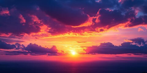 Fototapeta premium Beautiful orange and purple hues of the sky and clouds during sunset over the horizon background
