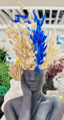 decorative vase in the shape of a woman's head with ears of corn