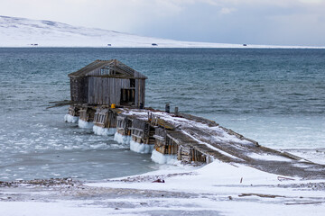 Dock in Coles bay, small abandoned mining settlement on Spitsbergen island in the Arctic