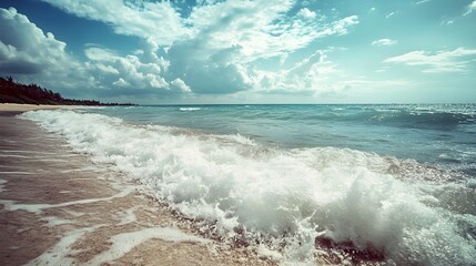 Ocean's Embrace: Captivating waves crash onto a sandy shore, under a sky dotted with clouds. The rhythmic dance of water and the vast expanse of the ocean provide an atmosphere of peace.