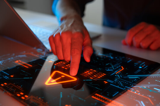 Man interacting with a holographic touchscreen interface in red color. Concept of cyber attack, malware, data breach, system hacking, virus, spyware, compromised information and urgent attention.