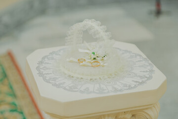 New wedding gold rings lie on a handmade white pillow happy wedding day. wedding ceremony
