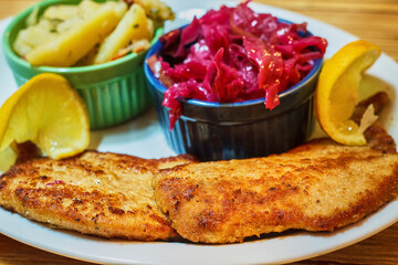 weinerschnitzle, breaded cutlet crispy fried with braised red cabbage and potato salad
