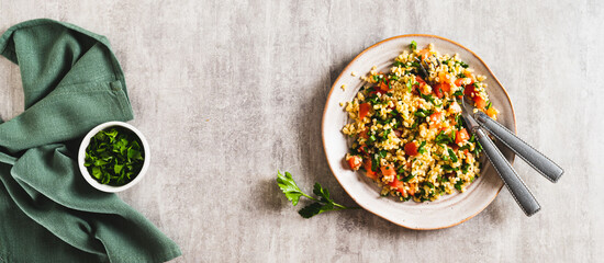 Traditional vegetarian tabbouleh salad on a plate on the table top view web banner
