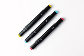 Colorful felt tip pens lying on white background