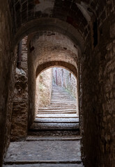 Fototapeta premium Narrow passage way with stone steps and arch, in the historic Jewish Quarter in the city of Girona in Catalonia, Spain. Jews lived and thrived in the city before the expulsion in 1492.