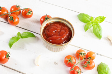Tomato paste, sauce, ketchup and cherry tomatoes on branches and basil