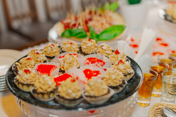 A beautifully decorated table with snacks on it with snacks and cakes for the holiday. The cakes in the foreground are large