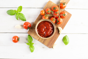 Tomato paste, sauce, ketchup and cherry tomatoes on branches and basil