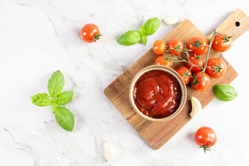 Tomato paste, sauce, ketchup and cherry tomatoes on branches and basil