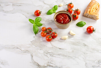 Tomato paste, sauce, ketchup and cherry tomatoes on branches and basil